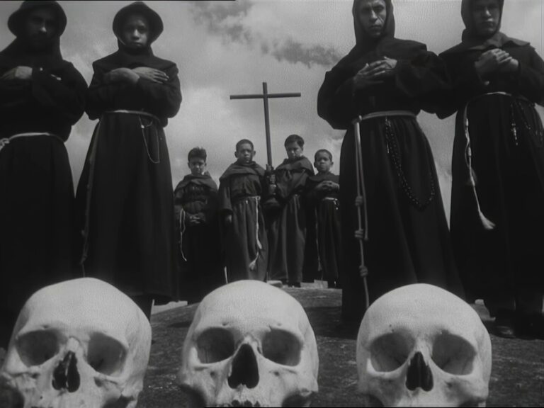 Hooded monks in dark robes stand with hands crossed around a central cross; foreground shows skulls, creating a grim, funeral scene.