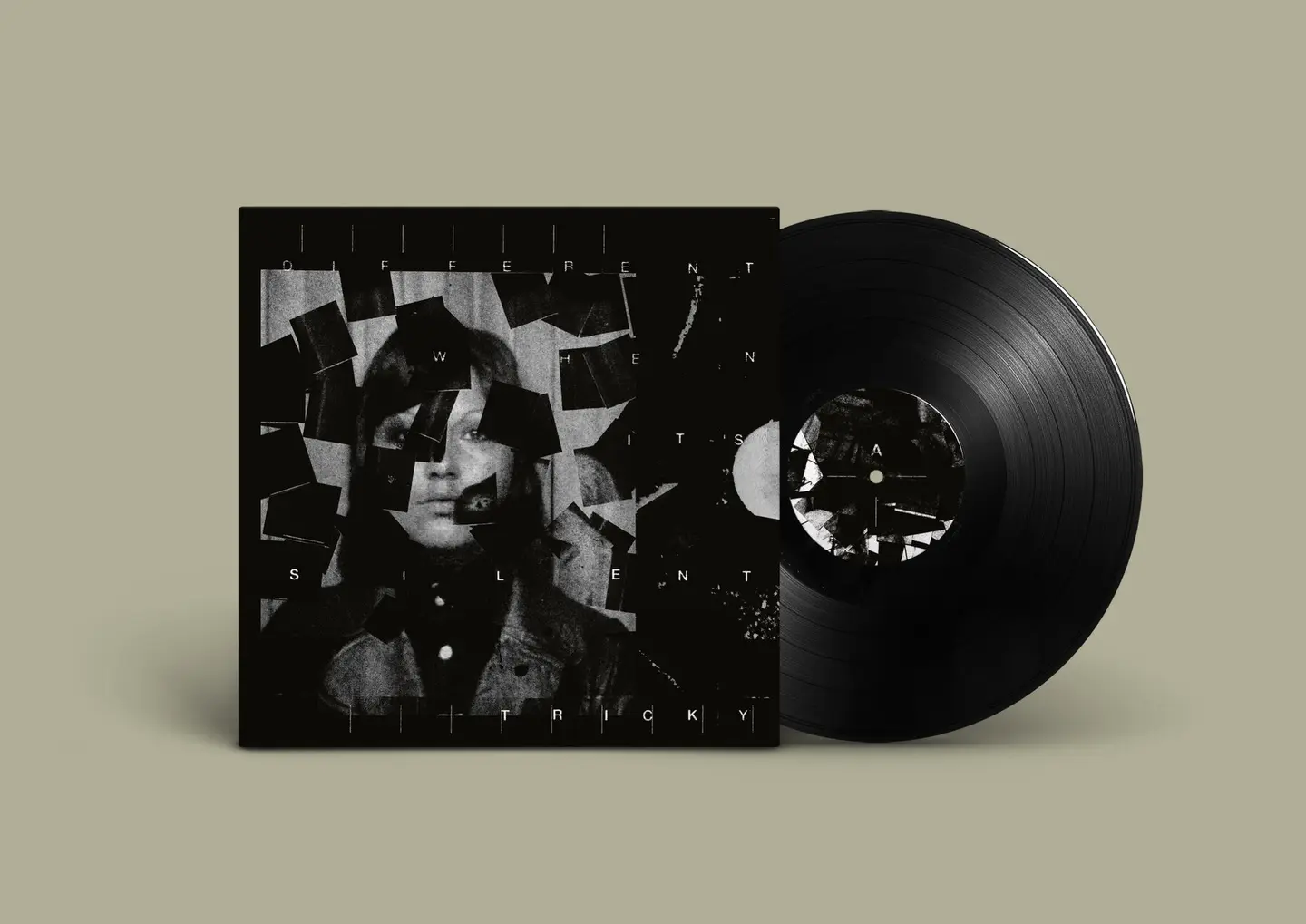 Vinyl record beside a square album cover with a fragmented grayscale portrait collage on a dark background. The beige backdrop is visible around them.