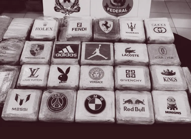 Grid of white blocks each showing a luxury brand logo (e.g., Rolex, Fendi, Ferrari, Maserati, Gucci) arranged in rows on a table.
