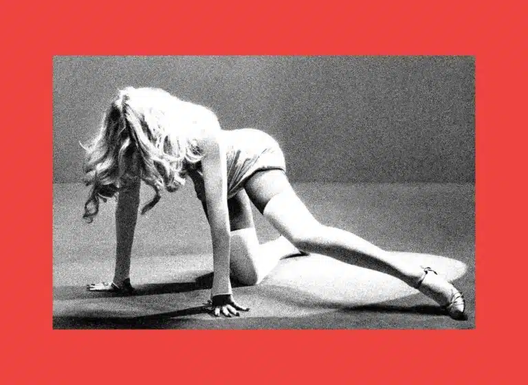 Woman in a backbend stretch on hands and knees, grayscale photo with a red border surrounding the image.