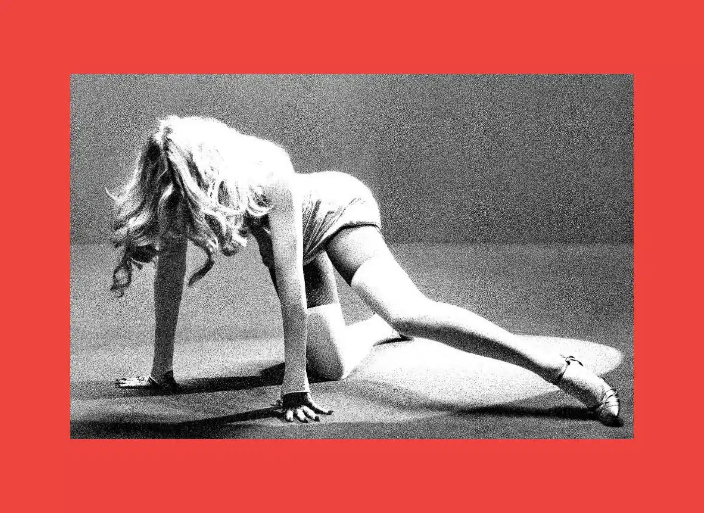 Woman in a backbend stretch on hands and knees, grayscale photo with a red border surrounding the image.