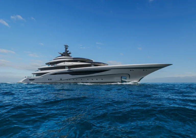 Luxury white multi-deck motor yacht sailing on the deep blue sea under a clear sky.